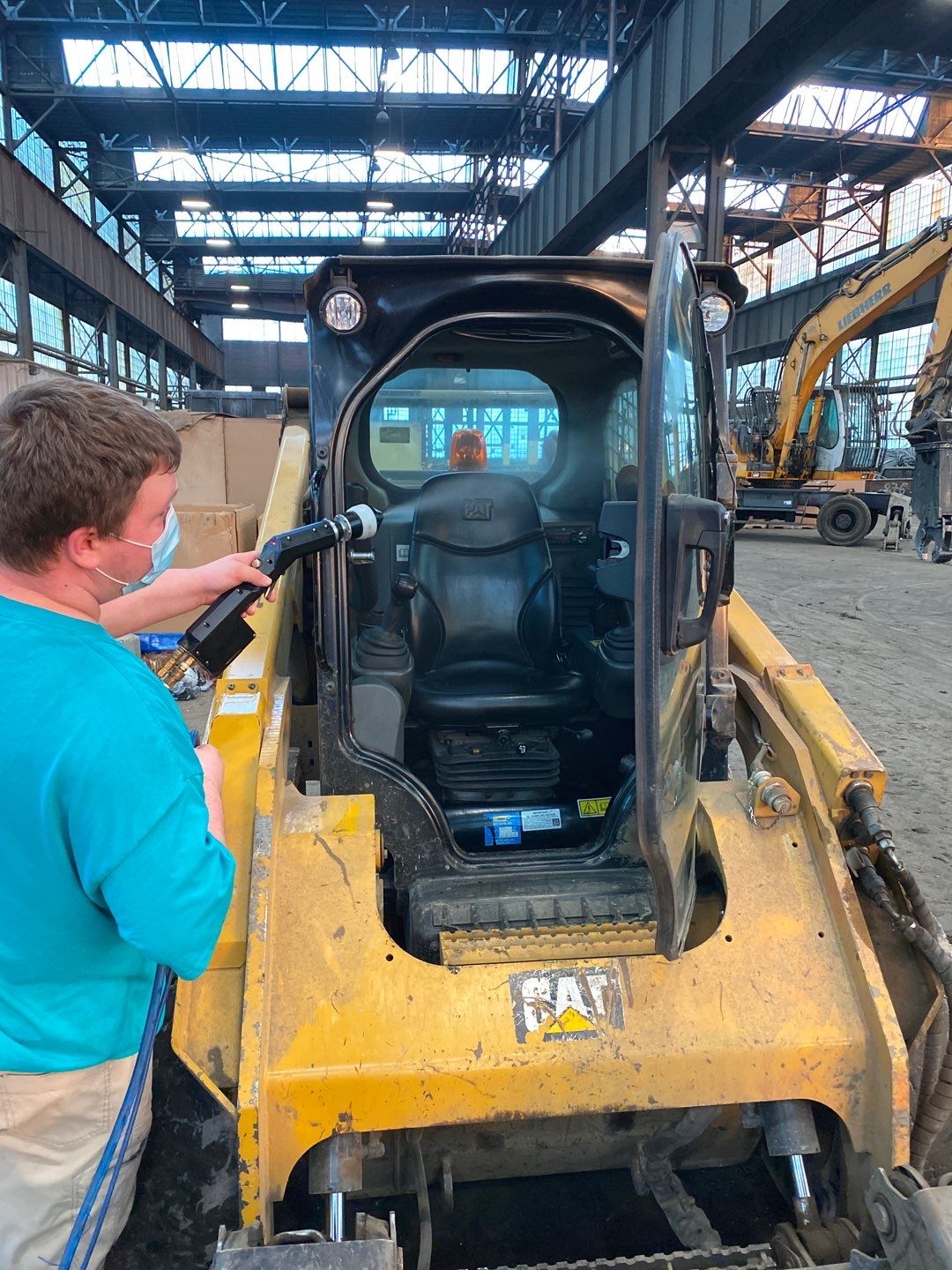 Worker cleaning a forklift